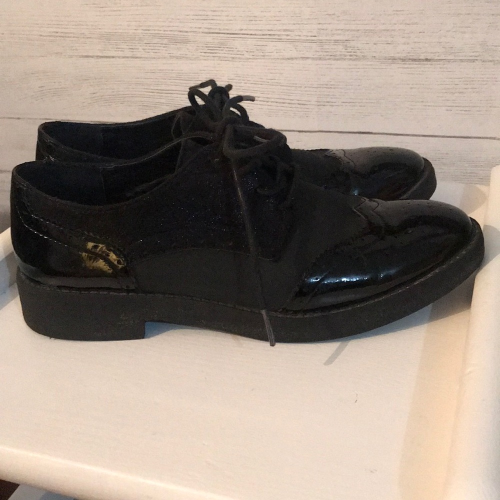 Shoes black and a little bit shiny.